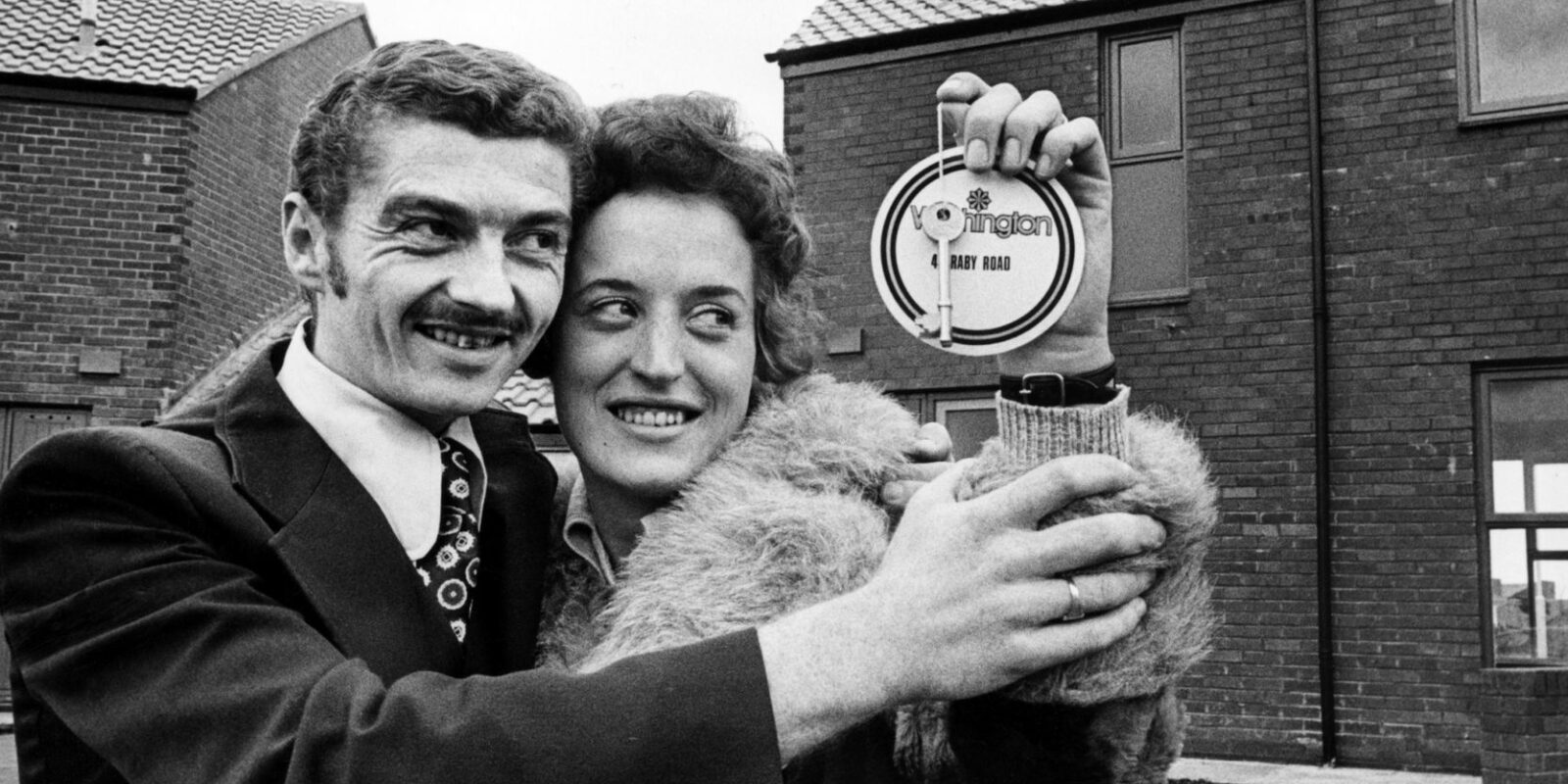 Roy and Evelyn Gilbert receive the key to their new home in Washington, 1976.